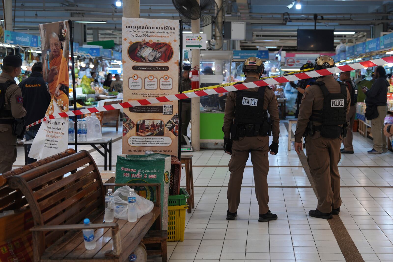 Policemen of a special operations unit at a crime scene at a market in Bangkok, Thailand, Monday, July 28, 2025 where police says six people are dead after a shooting incident. (AP Photo/Nava Sangthong)