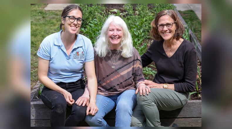 Janet Lawson (center) has been selected as a Dayton Daily News Community Gem. Lawson volunteers at Ruskin Elementary School with Libby Freeze (left) and Karen Raterman. The three instruct students on gardening. BRYANT BILLING / STAFF