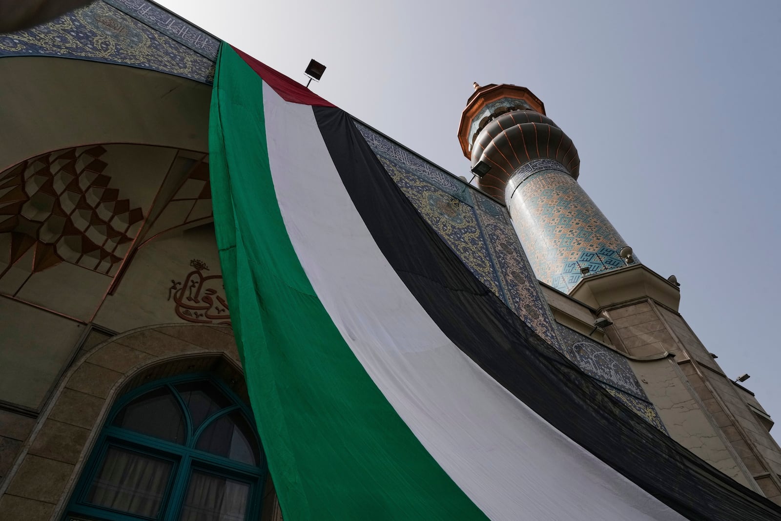 A huge Palestinian flag hangs on a mosque during an anti-Israel protest at the Felestin (Palestine) Sq. in Tehran, Iran, Wednesday, April 9, 2025. (AP Photo/Vahid Salemi)