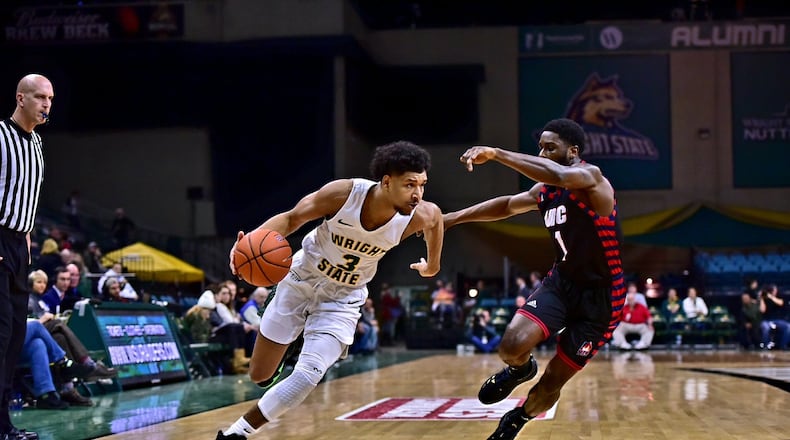 Wright State’s Mark Hughes tries to drive around UIC’s Marcus Ottey earlier this season at the Nutter Center. Josepth Craven/CONTRIBUTED