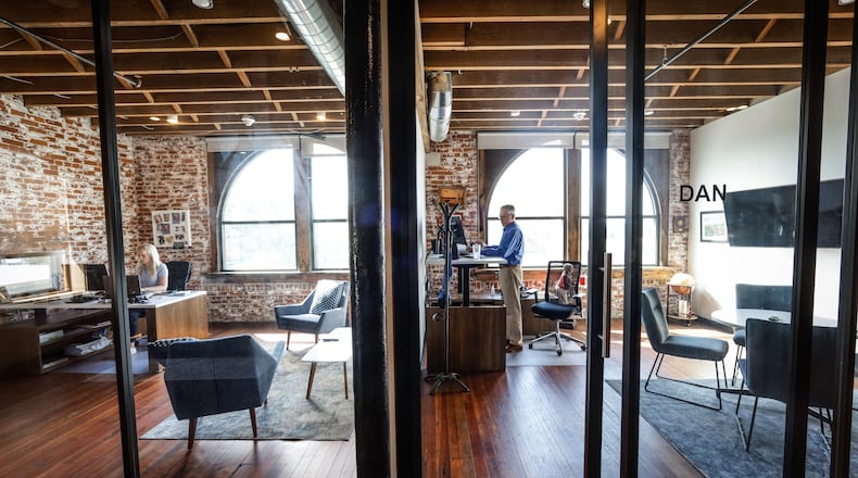 Carly Cox, left and Dan Marion of JJR Solutions work in their offices in the Avant Garde Building on East Third Street in Dayton. JIM NOELKER/STAFF