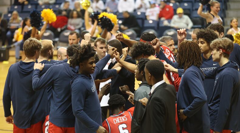 Dayton huddles before a game against La Salle on Tuesday, Jan. 23, 2024, at Tom Gola Arena in Philadelphia. David Jablonski/Staff