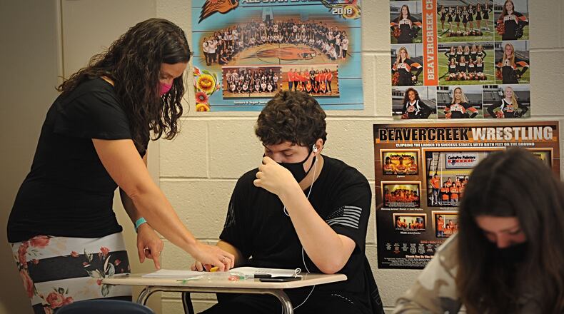 A Beavercreek High School teacher works with a student on Oct. 8, 2020.