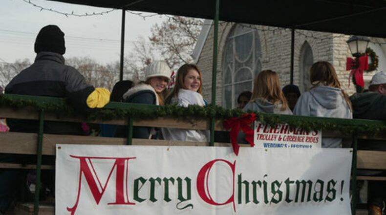 Festival-goers at Christmas in Historic Springboro ride in a horse-drawn cart on Saturday, Nov. 22.