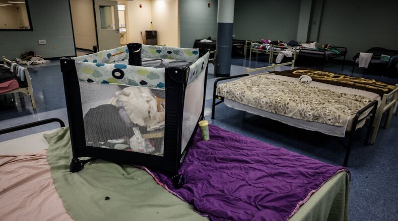 The family dormitory at St. Vincent De Paul shelter pushes beds together so mothers and children can be close. JIM NOELKER/STAFF