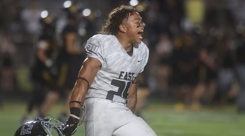 Lakota East's Ryder Hooks celebrates after a victory against Centerville on Friday, Aug. 22, 2025, at Centerville Stadium. David Jablonski/Staff
