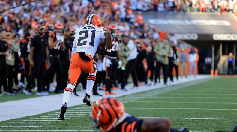Cleveland Browns' Denzel Ward (21) returns an interception for a touchdown during the first half of an NFL football game against the Cincinnati Bengals, Sunday, Nov. 7, 2021, in Cincinnati. (AP Photo/Aaron Doster)