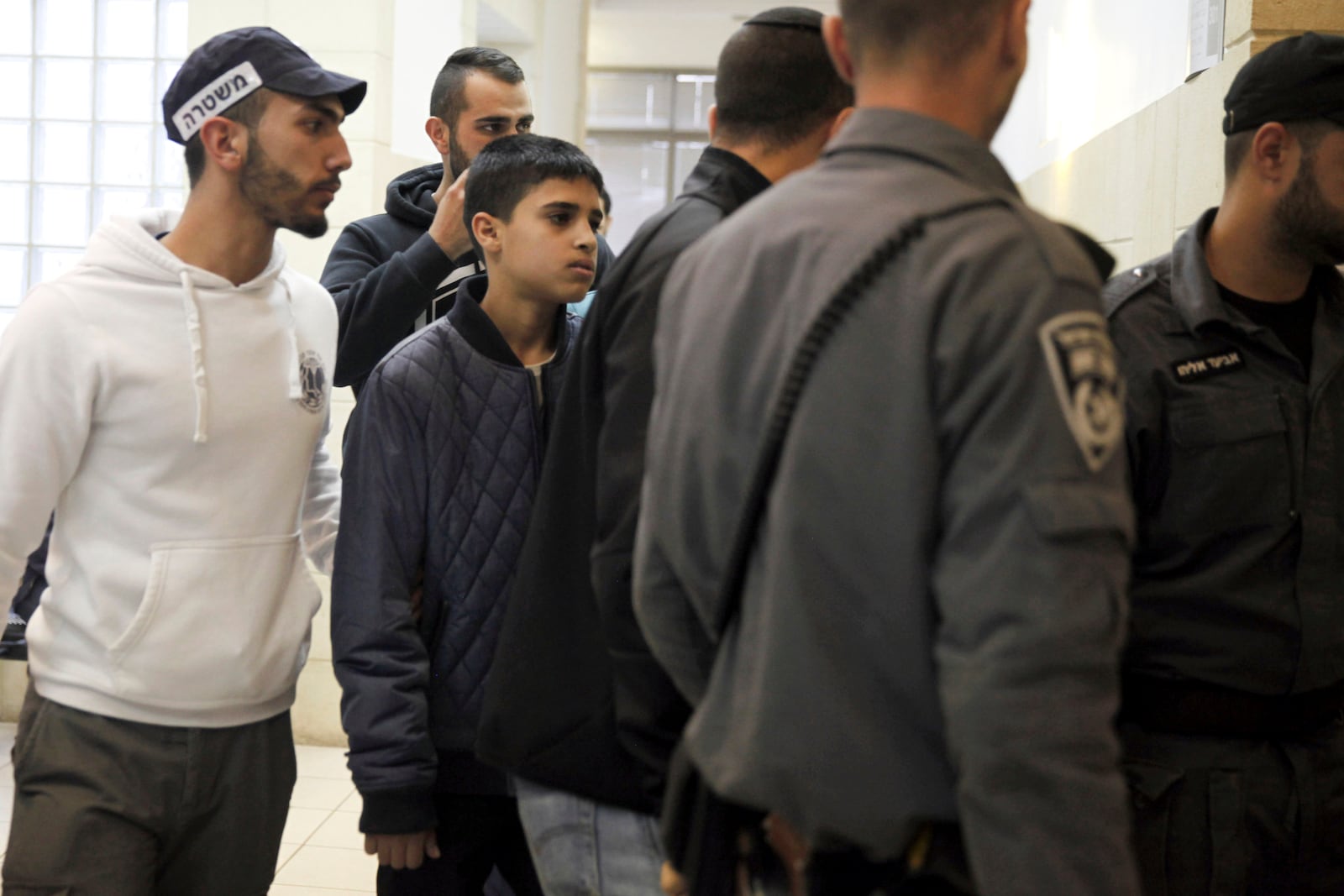FILE - Ahmed Manasra, a 13-year-old Palestinian is brought to a court in Jerusalem, Tuesday Nov. 10, 2015. According to the indictment, Manasra and his cousin Hassan, 15, stabbed two Israelis in an east Jerusalem neighborhood. (AP Photo/Mahmoud Illean, File)