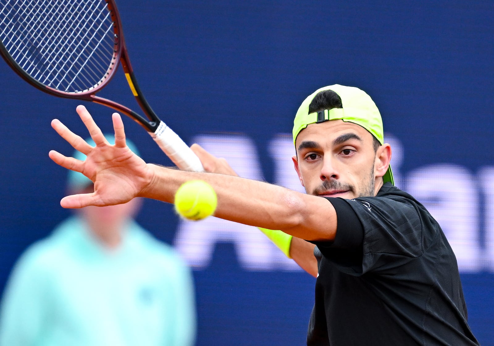 Argentina's Francisco Cerundolo returns the ball to Belgium's David Goffin during the men's singles quarterfinal match at the Munich tennis tournament, in Munich, Germany, Friday April 18, 2025. (Sven Hoppe/dpa via AP)