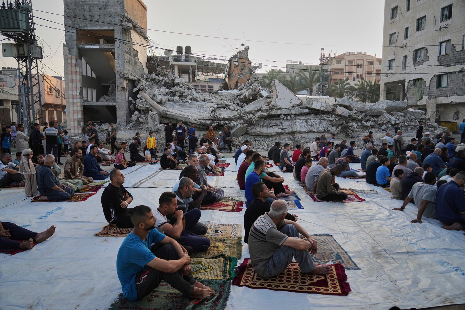 Palestinians gather for Eid al-Adha prayers beside the ruins of a mosque destroyed by Israeli bombardment, in Deir al-Balah, Gaza on Friday, June 6, 2025. (AP Photo/Abdel Kareem Hana)