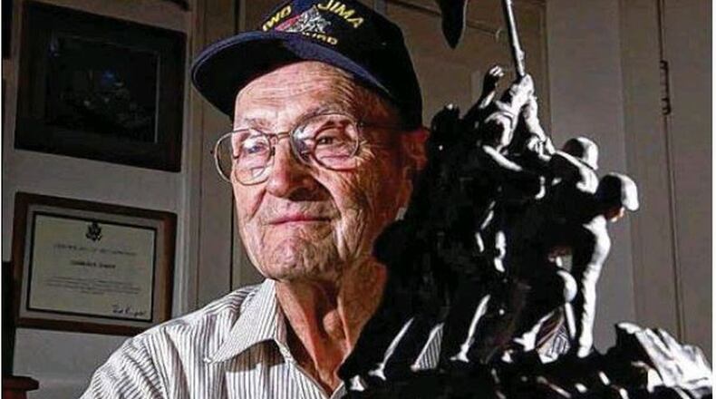 Charlie Baker, of Kettering, one of the men who helped guard the flag the Marines planted on the South Pacific island in the legendary 1945 battle, has died.