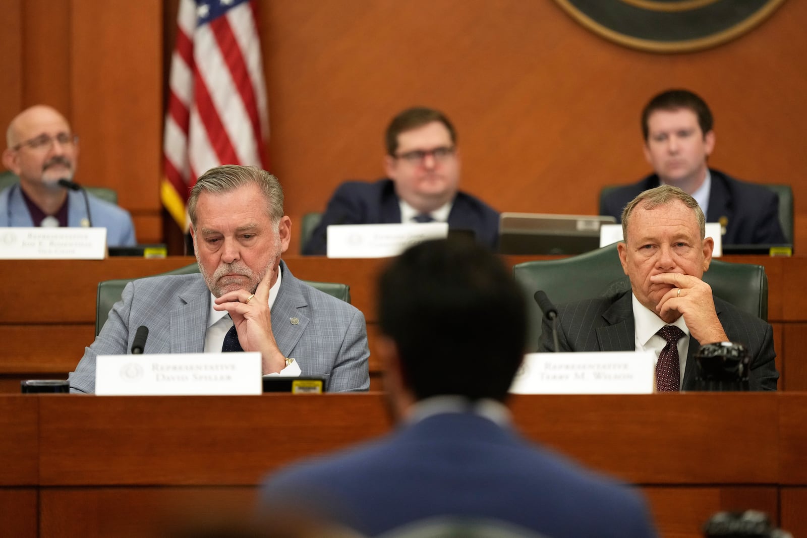 Texas state Reps. David Spiller, left, and Terry M. Wilson, right, listen to U.S. Rep. Greg Casar, center, as he gives testimony during a hearing on redistricting at the Texas Capitol, Thursday, July 24, 2025, in Austin, Texas. (AP Photo/Eric Gay)