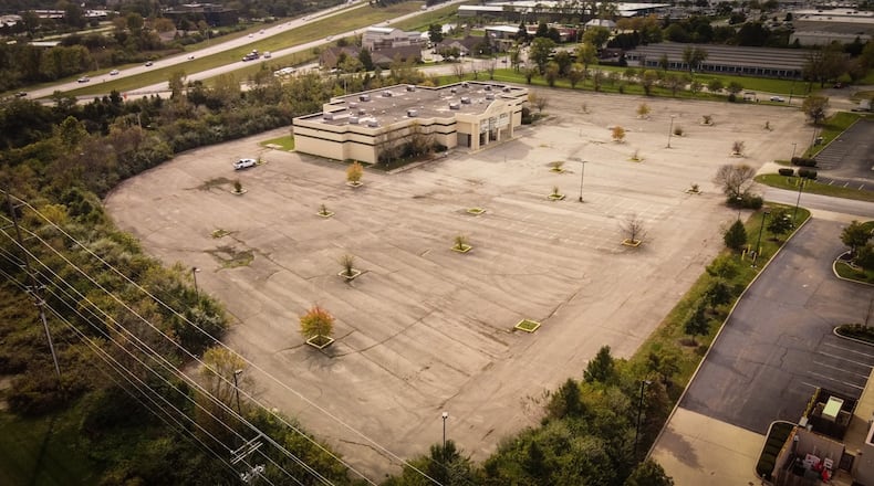 Kenwood Dealer Group bought the former Danbarry Cinemas building along with about eight acres at 8300 Lyons Ridge Road in Miami Twp. Area business owners previously had been divided about whether or not a car dealership is something that fits in the area, but recently told trustees that they support the project. JIM NOELKER/STAFF