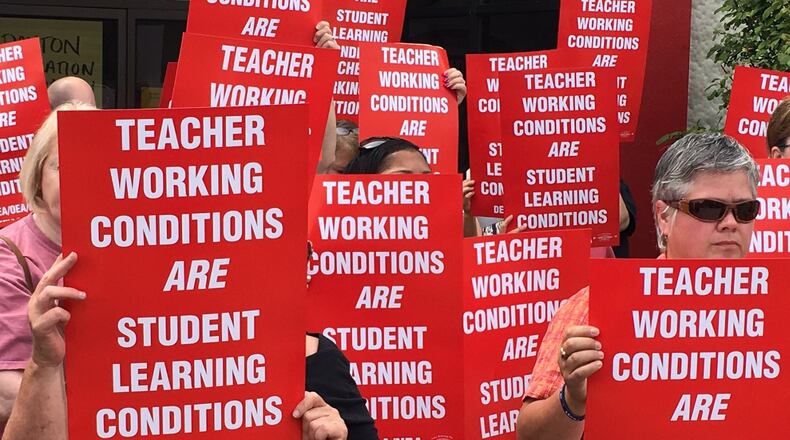 Dayton Education Association leaders said more than 98 percent of its members voted in favor of striking before classes resume Aug. 15, if no agreement is reached. Teachers held signs outside the IBEW union hall on Poe Avenue following their vote on Aug. 1, 2017. NATHAN DAVIS/STAFF