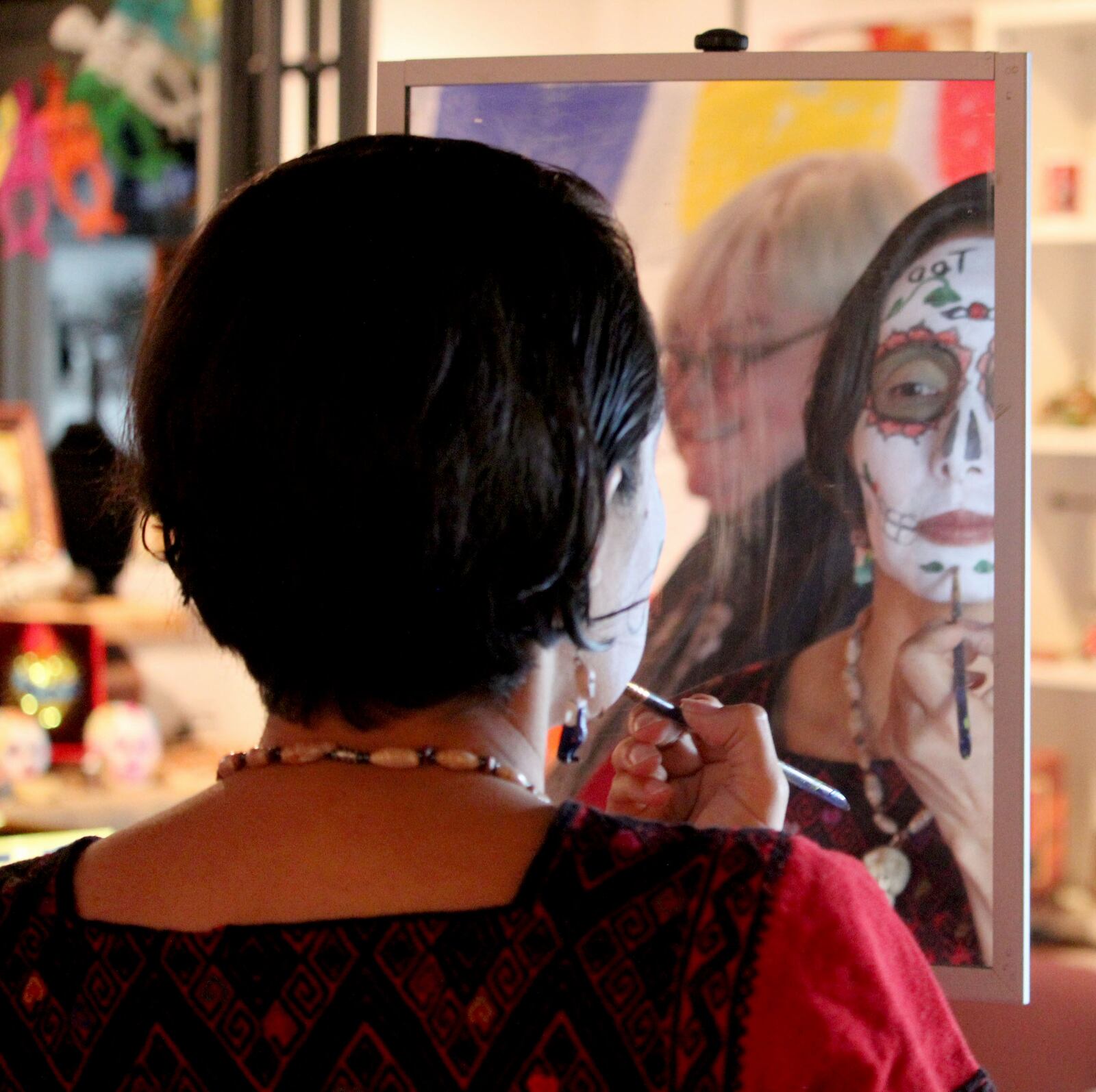 Dayton has celebrated El Dia de los Muertos  since 2012. Gabriela Pickett, the owner of  Missing Peace Art Space, is an organizer.  Artist  MB Hopkins can be seen in the background.  Photo Amelia Robinson