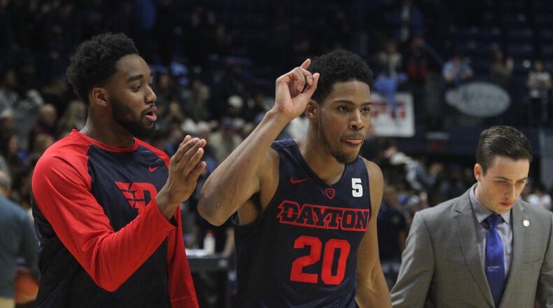 Josh Cunningham and Xeyrius Williams leave the court after a win at Rhode Island. David Jablonski/Staff