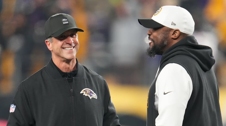 Baltimore Ravens head coach John Harbaugh, left, and Pittsburgh Steelers head coach Mike Tomlin, right, talk before an NFL football game Sunday, Jan. 4, 2026, in Pittsburgh. (AP Photo/Gene J. Puskar)