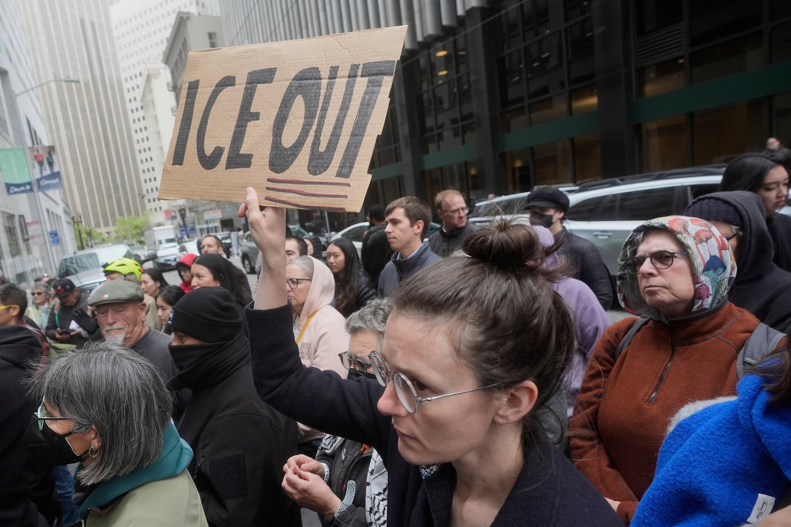 FILE - A person holds up a sign during a news conference and rally by immigrant justice organizations and advocates protesting ICE arrests in San Francisco, Wednesday, May 28, 2025. (AP Photo/Jeff Chiu, File)