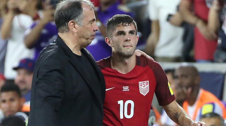 USA head coach Bruce Arena puts his arm around player Christian Pulisic (10) during action against Panama during World Cup qualifier match at Orlando City Stadium on Friday, Oct. 6, 2017, in Orlando, Fla. (Stephen M. Dowell/Orlando Sentinel/TNS)