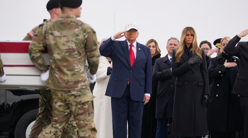 An Army carry team moves a flag-draped transfer case with the remains of U.S. Army Reserve soldier Sgt. 1st Class Nicole Amor, of White Bear Lake, Minn., who was killed in a drone strike at a command center in Kuwait after the U.S. and Israel launched its military campaign against Iran, past President Donald Trump and first lady Melania Trump during a casualty return, Saturday, March 7, 2026, at Dover Air Force Base, Del. (AP Photo/Mark Schiefelbein)