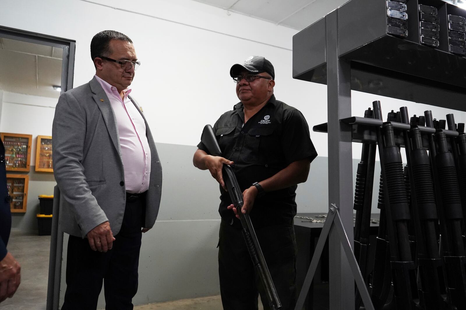 Costa Rica's Justice and Peace Minister Gerald Campos Valverde, left, tours the armory at the Terrorist Confinement Center in Tecoluca, El Salvador, Friday, April 4, 2025. (AP Photo/Salvador Melendez)