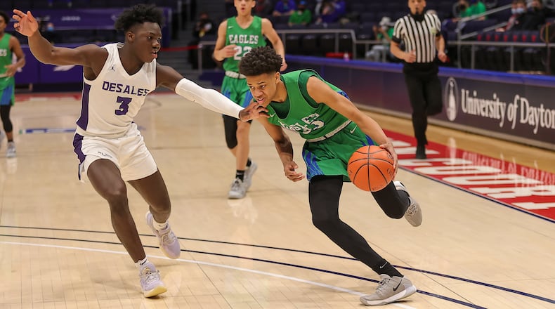 Chaminade Julienne High School freshman Jonathan Powell drives past Columbus St. Francis DeSales senior Obed Achirem during their Division II state semifinal game on Saturday afternoon at UD Arena. DeSales won 51-34. Michael Cooper/CONTRIBUTED