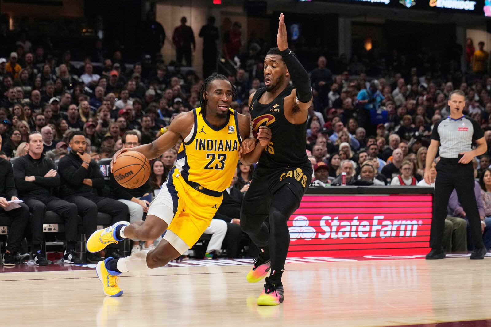Indiana Pacers forward Aaron Nesmith, left, tries to drive by Cleveland Cavaliers guard Donovan Mitchell during the first half in Game 5 of an Eastern Conference semifinal NBA basketball playoff Tuesday, May 13, 2025, in Cleveland. (AP Photo/Sue Ogrocki)