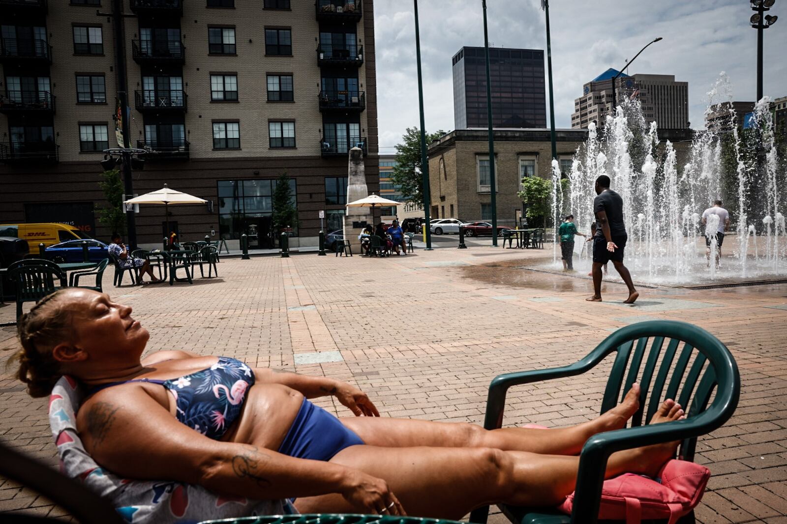 Annie Chiles, from Greenville, absorbs some rays at the RiverScape MetroPark Tuesday June 18, 2024. This week the Dayton area is expecting near100 degree temperatures all week. JIM NOELKER/STAFF