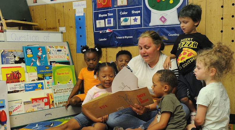 Breanna Sharp reads to her preschoolers Tuesday July 6, 2021 at the On Purpose Academy just north of downtown Dayton. Preschool Promise, which has served 4-year-olds in Dayton and Montgomery County for years, is now offering services to 3-year-olds in the city of Dayton. MARSHALL GORBY\STAFF
