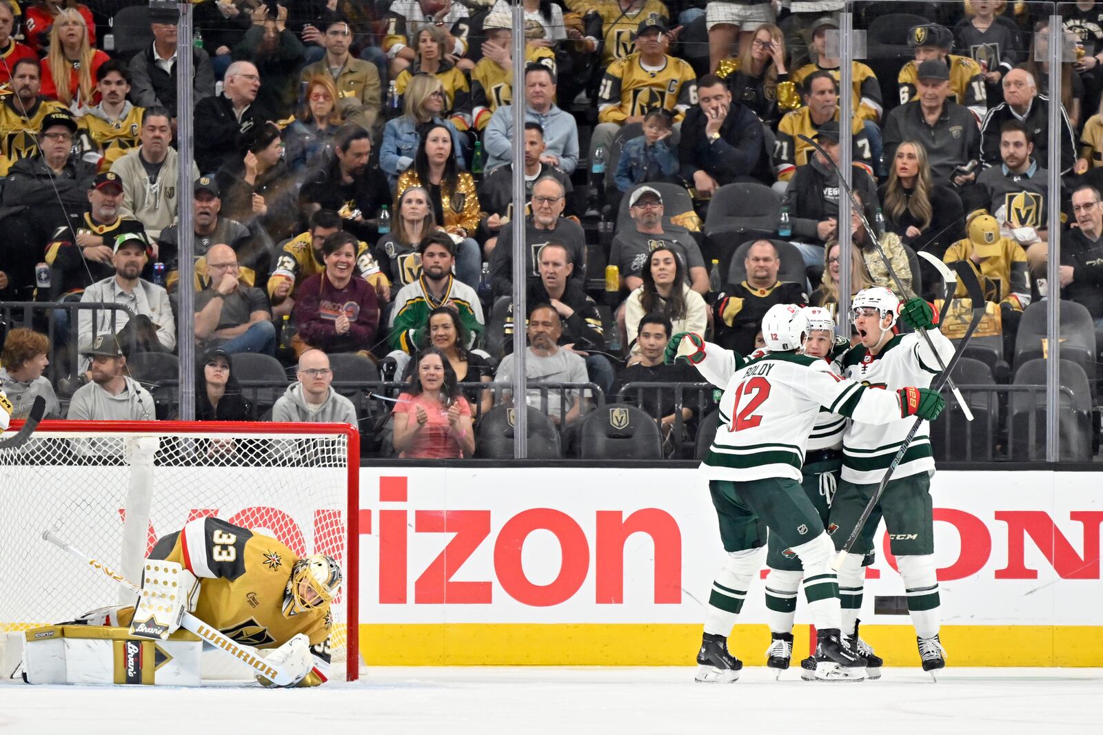 Minnesota Wild players celebrate a goal by left wing Kirill Kaprizov against Vegas Golden Knights goaltender Adin Hill (33) during the second period of Game 2 of a first-round NHL hockey playoff series Tuesday, April 22, 2025, in Las Vegas. (AP Photo/David Becker)