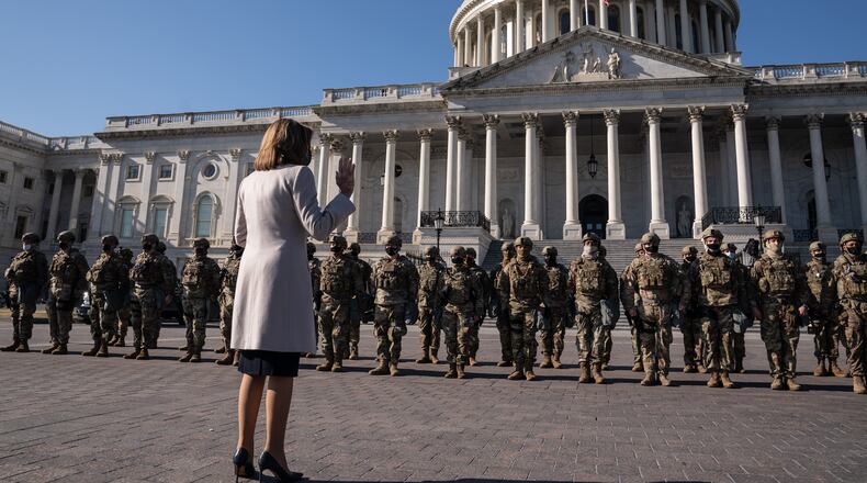 Speaker of the House Nancy Pelosi (D-Calif.) meets with National Guard troops outside the Capitol in Washington on Wednesday, Jan. 13, 2021. (Anna Moneymaker/The New York Times)