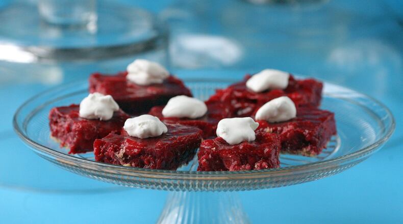 Double Berry Pie Squares are made with fresh strawberries and frozen raspberries simmered with gelatin. A graham-cracker crust makes up the base for the fruity center of the squares, and a dollop of (sugar-free) Cool Whip on top. (Hillary Levin/St. Louis Post-Dispatch/TNS)