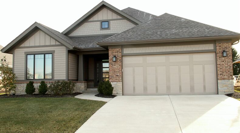 The split floor plan ranch has a full basement with finished areas that include a recreation room with wet bar area, a full bathroom and a possible fourth bedroom. The main level has an open-concept social area with a dual-sided gas fireplace as the centerpiece. CONTRIBUTED PHOTOS BY KATHY TYLER