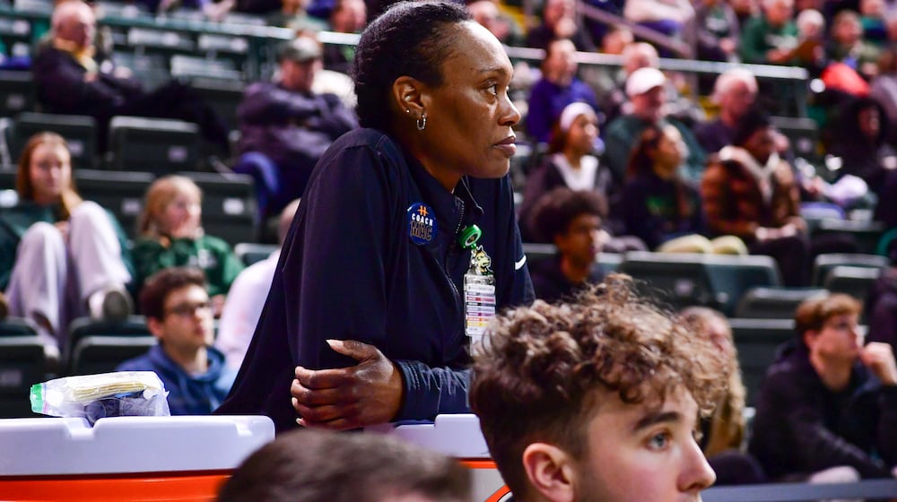 Wright State men's basketball athletic trainer LaShaunta' Jones (left) leans on a Gatorade jug during their game against Northern Kentucky on Feb. 21, 2025 at the Nutter Center. JOSEPH R. CRAVEN / CONTRIBUTED PHOTO