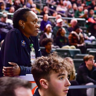 Wright State men's basketball athletic trainer LaShaunta' Jones (left) leans on a Gatorade jug during their game against Northern Kentucky on Feb. 21, 2025 at the Nutter Center. JOSEPH R. CRAVEN / CONTRIBUTED PHOTO