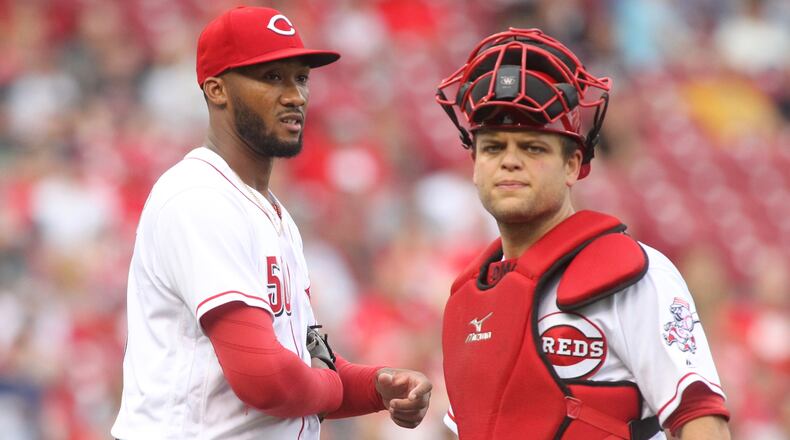 Reds pitcher Amir Garrett and Devin Mesoraco pause after Garrett was hit on the hand by a groundball during a game against Indians on Tuesday, May 23, 2017, at Great American Ball Park in Cincinnati. David Jablonski/Staff