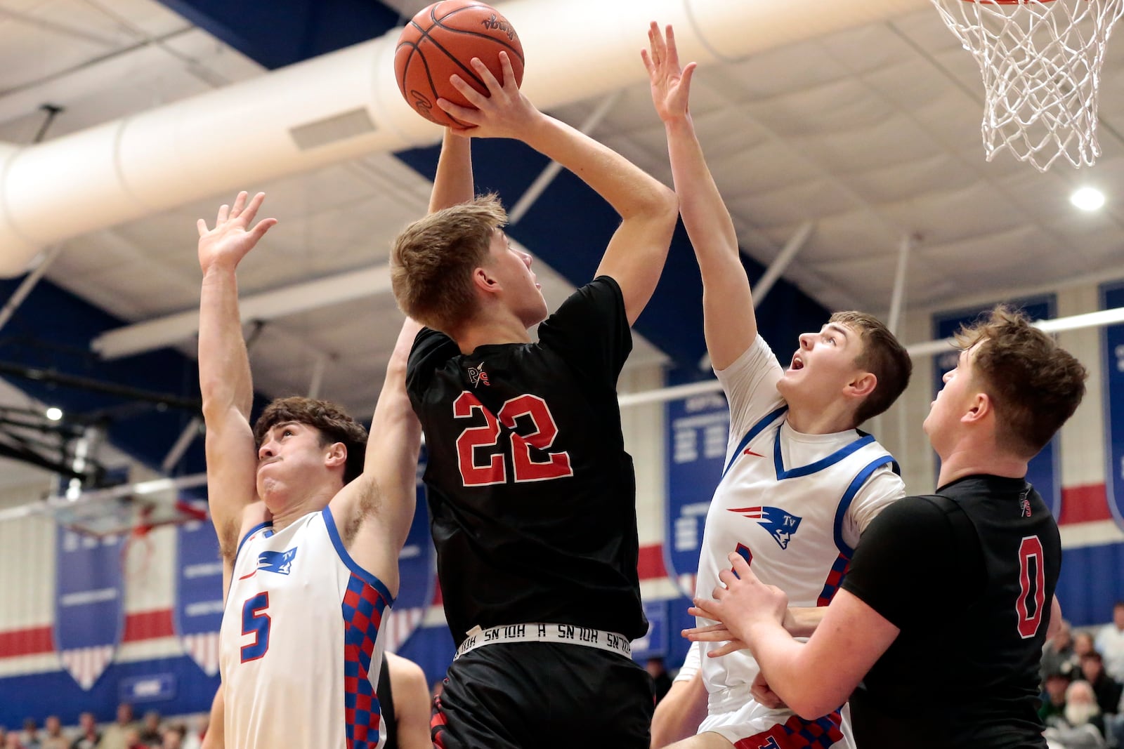 Preble Shawnee junior Braylon Dorrel shoots the ball over Tri-Village senior Trey Sagester (left) and senior Noah Finkbine during their game on Friday, Feb. 13, 2026, in New Madison. The Patriots won 55-20. STEVEN WRIGHT / STAFF
