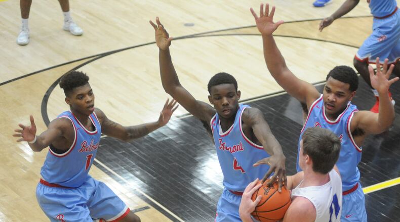 Miamisburg’s Drew Berry (with ball) is surrounded by Belmont’s Jeff Hunt (left), Phil Harewood and Latrell Estes. Miamisburg defeated Belmont 71-59 in a boys D-I high school basketball sectional semi at Centerville on Tue., Feb. 28, 2018. MARC PENDLETON / STAFF