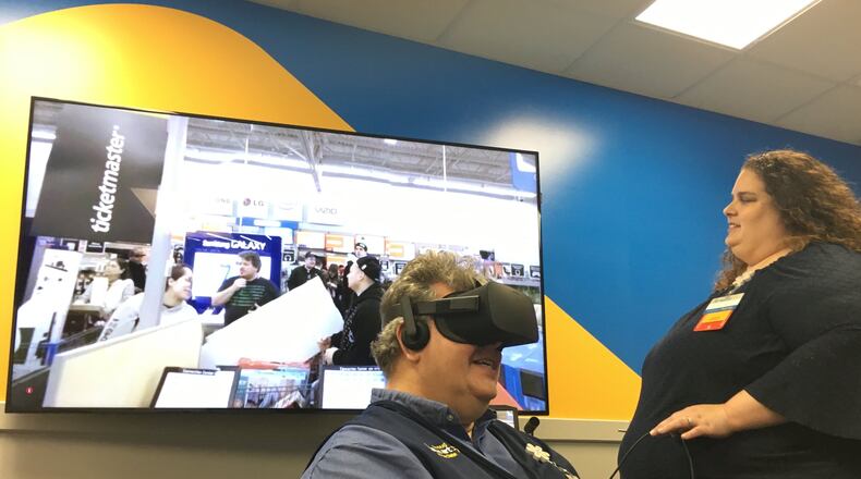 Walmart uses Virtual Reality to train managers at its Training Academy in West Chester. Rachel Hucks directs John Philippo through a training exercise about handling high-stress situations during busy shopping holidays like Black Friday. STAFF PHOTO / HOLLY SHIVELY