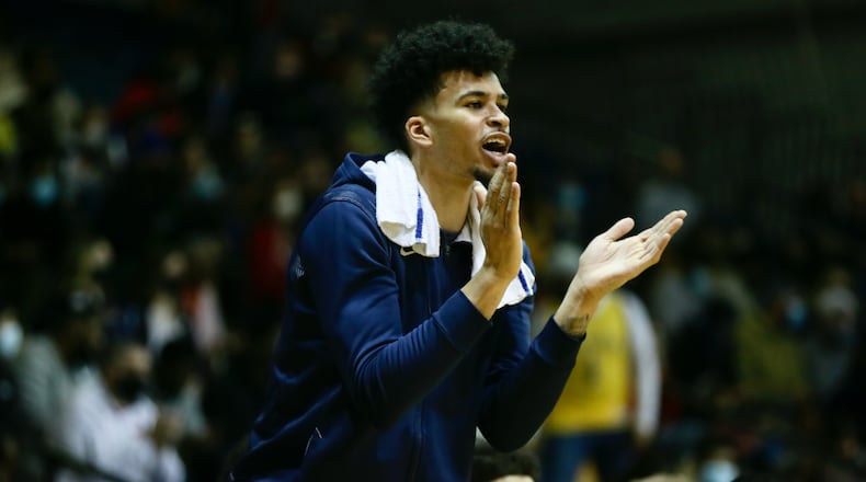 Dayton's Toumani Camara claps during a game against La Salle on Saturday, Feb. 26, 2022, at UD Arena. David Jablonski/Staff