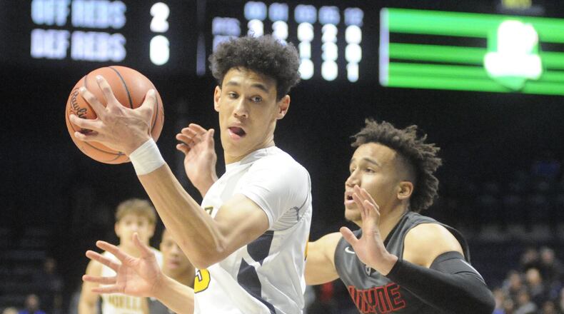 Wayne’s L’Christian “Blue” Smith (right) was matched against Moeller 6-10 center Jaxson Hayes. Moeller defeated Wayne 65-53 in a boys high school basketball D-I regional final at Xavier University Cintas Center in Cincinnati on Friday, March 16, 2018. MARC PENDLETON / STAFF