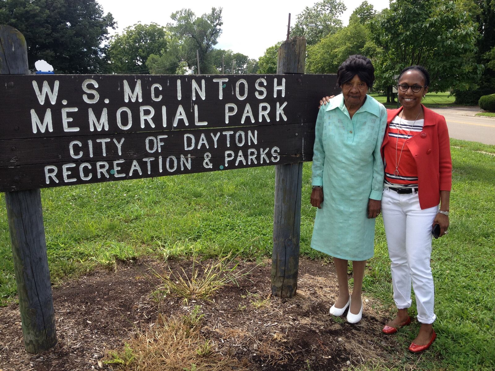 Photo of  Charlene McIntosh, W.S. McIntosh’s widow,  in a Dayton park named in her husband's honor. She stands with her granddaughter, Tynnetta Mcintosh.