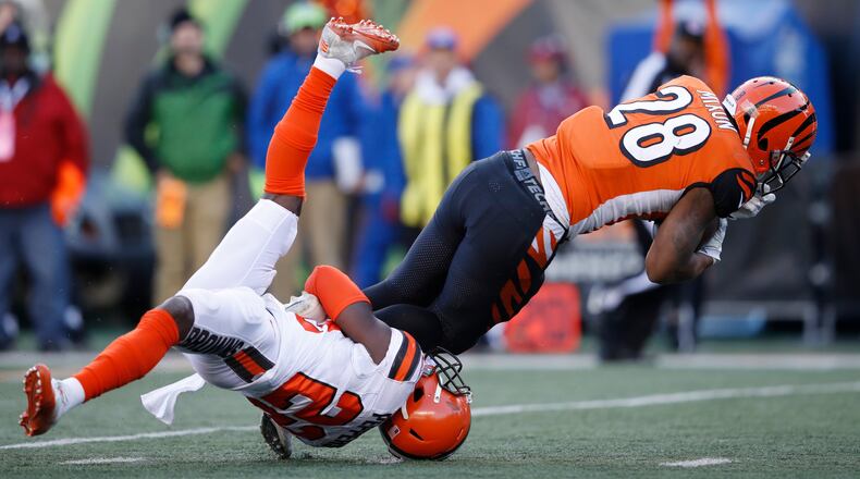 CINCINNATI, OH - NOVEMBER 26: Joe Mixon #28 of the Cincinnati Bengals runs over Jabrill Peppers #22 of the Cleveland Browns in the second half of a game at Paul Brown Stadium on November 26, 2017 in Cincinnati, Ohio. The Bengals won 30-16. (Photo by Joe Robbins/Getty Images)