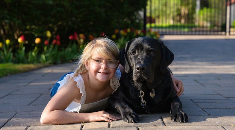 Emma Brown with Sloane, her skilled companion dog. Sloane is not able to attend school with Emma, but is there for her at home whenever she needs him. CONTRIBUTED