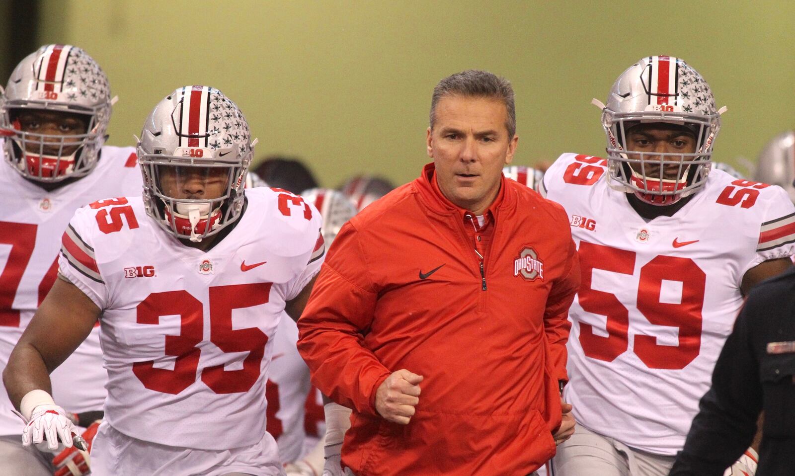 Ohio State’s Urban Meyer leads the team onto the field before a game against Wisconsin on Dec. 2, 2017, at Lucas Oil Stadium in Indianapolis. David Jablonski/Staff