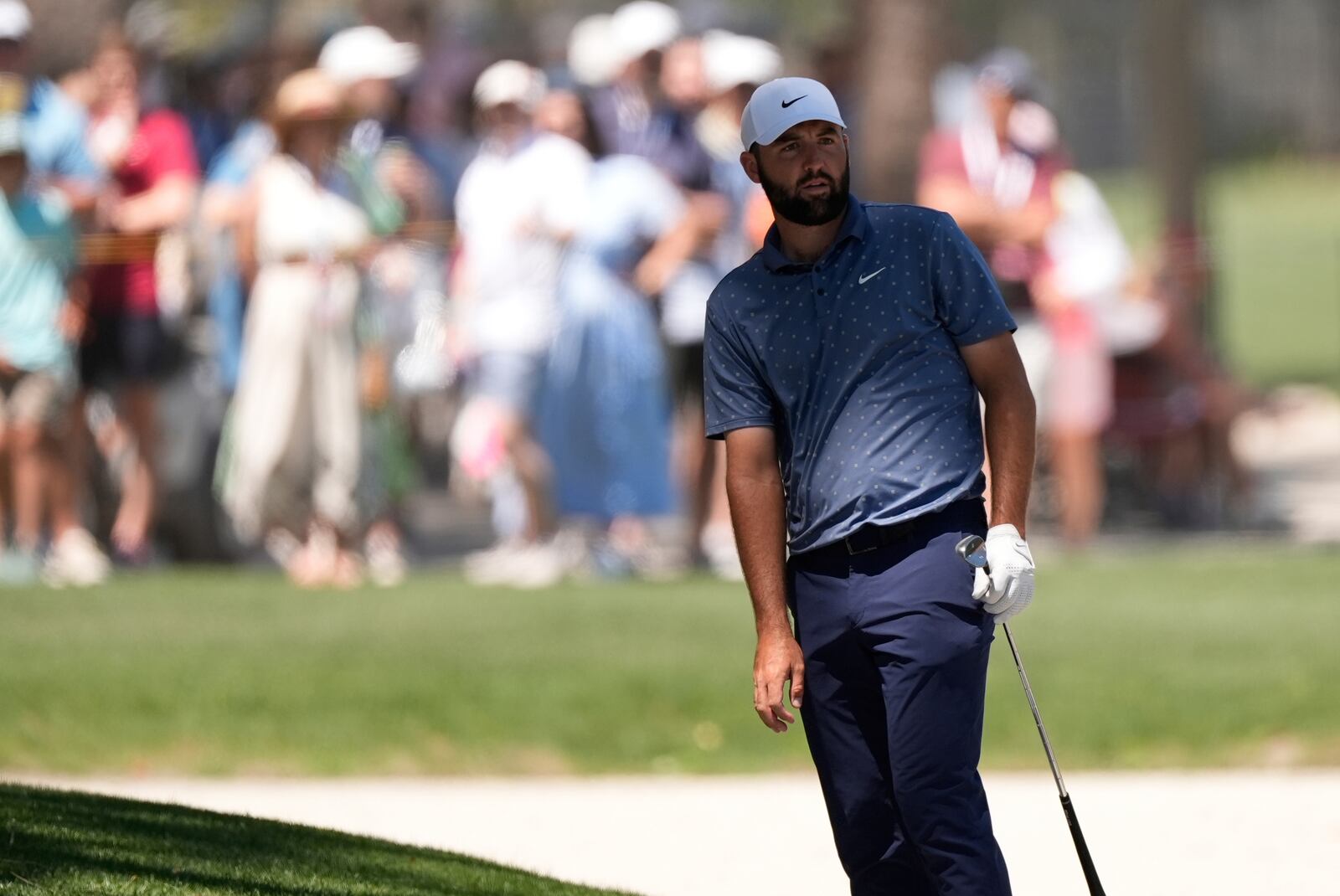 Scottie Scheffler watches his shot from the bunker on the second hole during the third round of the RBC Heritage golf tournament, Saturday, April 19, 2025, in Hilton Head Island, S.C. (AP Photo/Mike Stewart)