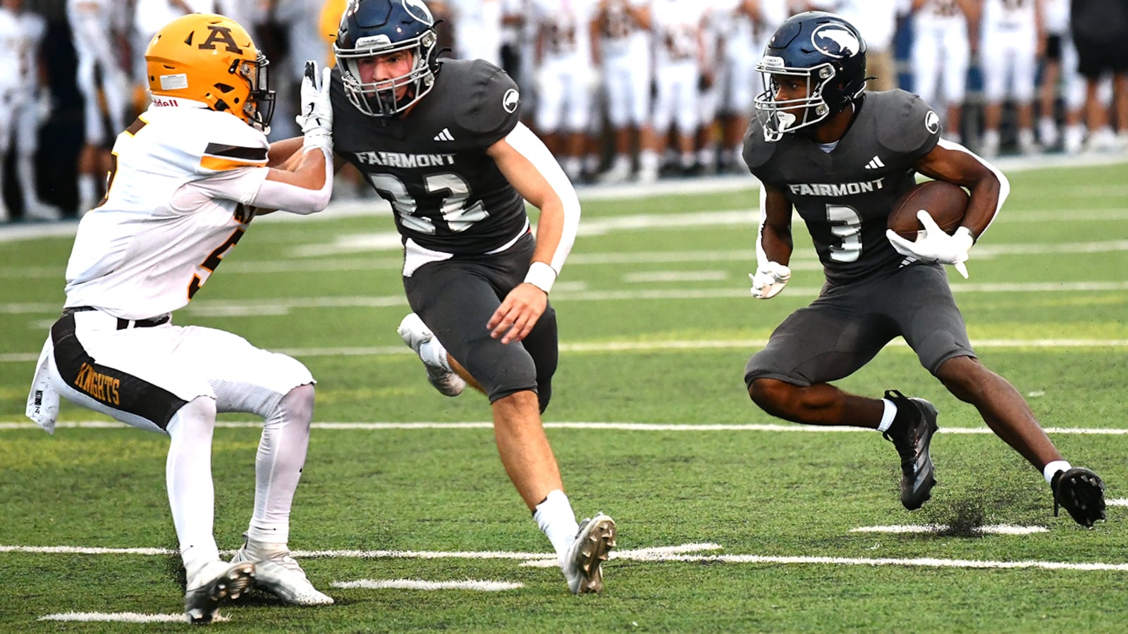 Fairmont's Kameron Thornton gets a block from Nolan Stringer as he cuts back against Alter during Thursday night's season opener at Roush Stadium. JEFF GILBERT/CONTRIBUTED