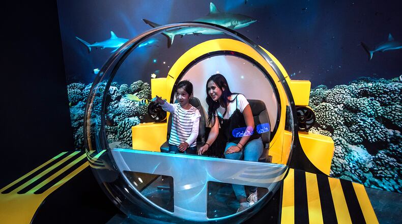 A partial replica of a Triton submersible provides a great photo opportunity for "Unseen Oceans" visitors who have cameras at the ready.  ©AMNH/D. Finnin