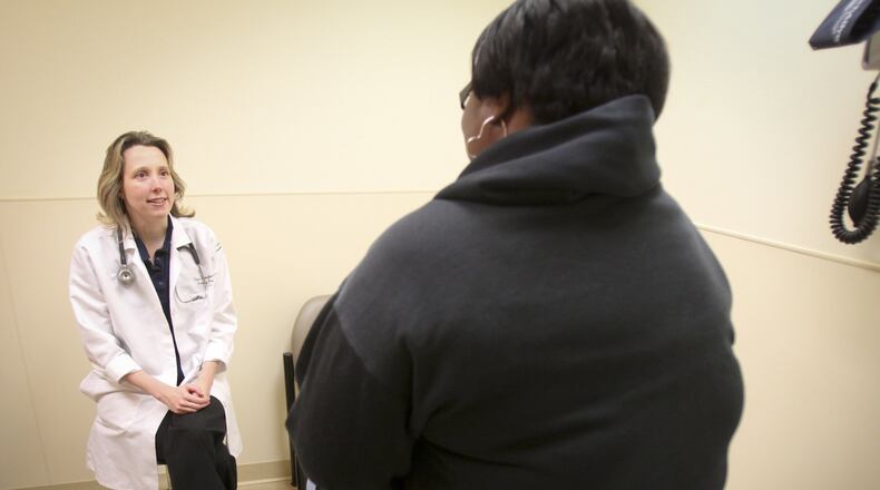 Dr. Tara Scheufler of the Middletown Community Health & Dental Center talks with a patient, Thursday, Oct. 17, 2013. The center serves many Medicaid patients.