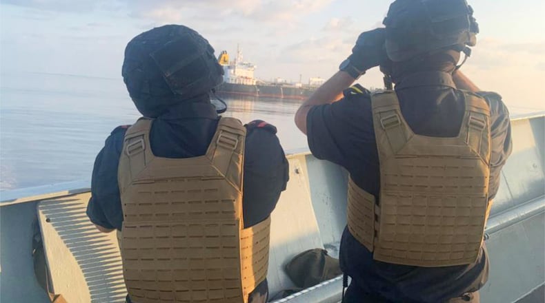 Two members of the European Union's Operation Atalanta aboard the ESPS Victoria watch the Hellas Aphrodite off the coast of Somalia in the Arabian Sea on Friday, Nov. 7, 2025. (European Union's Operation Atalanta via AP)
